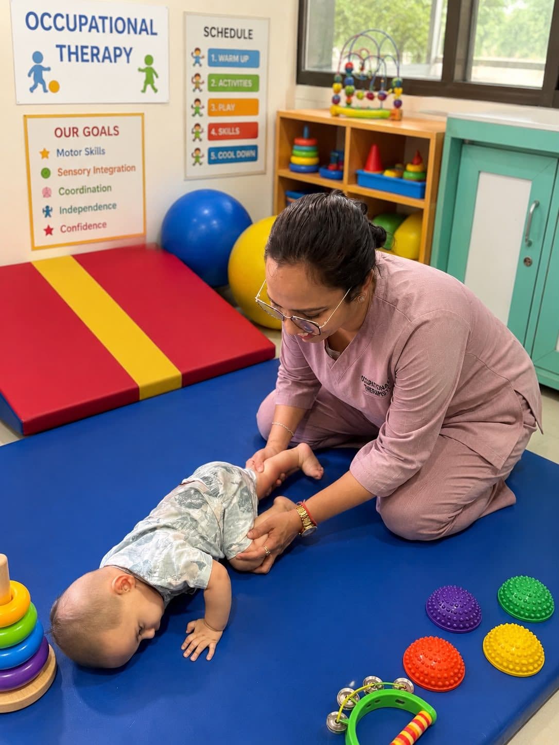 Gentle leg-strengthening exercise for an infant on the therapy mat